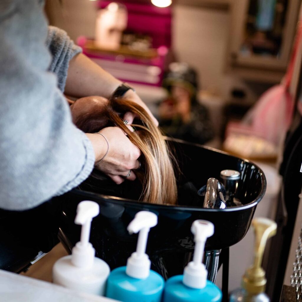 woman washing a womans hair