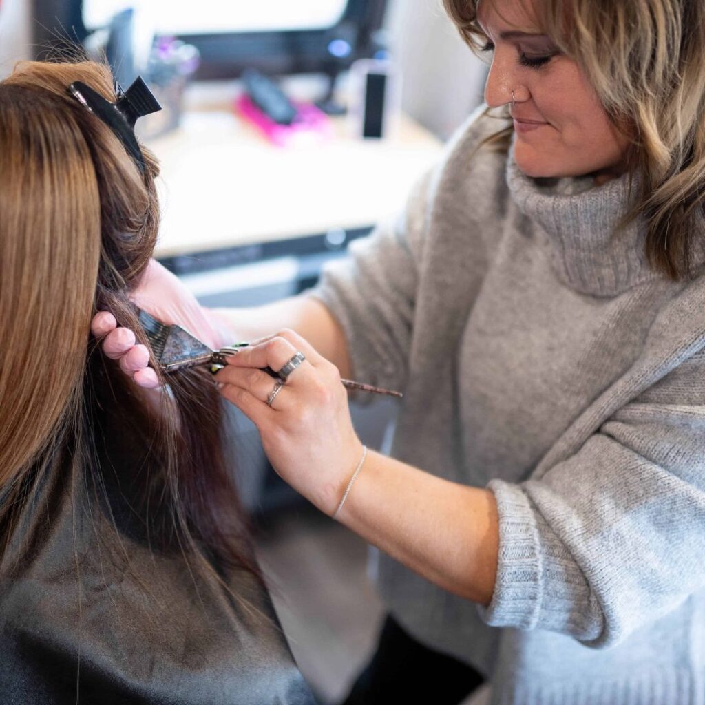 woman coloring a woman's hair