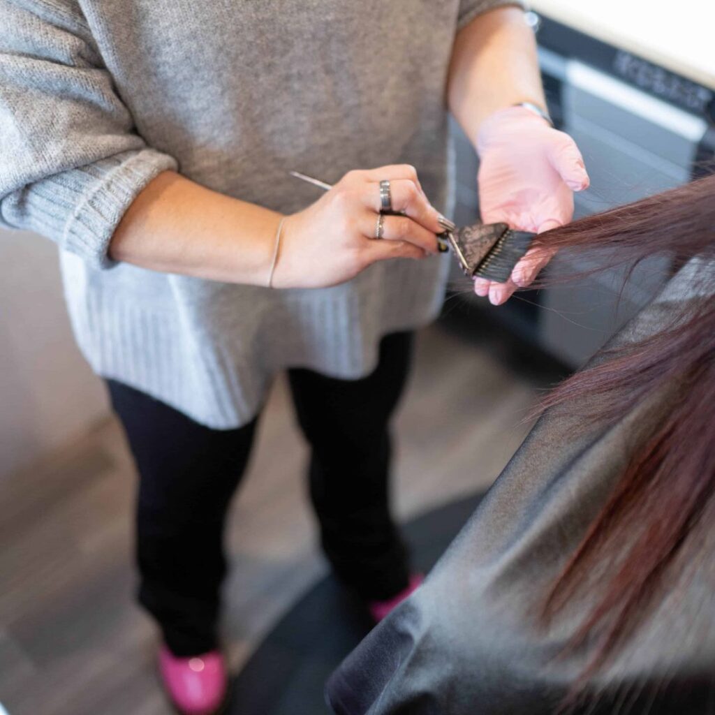 woman coloring a womans hair