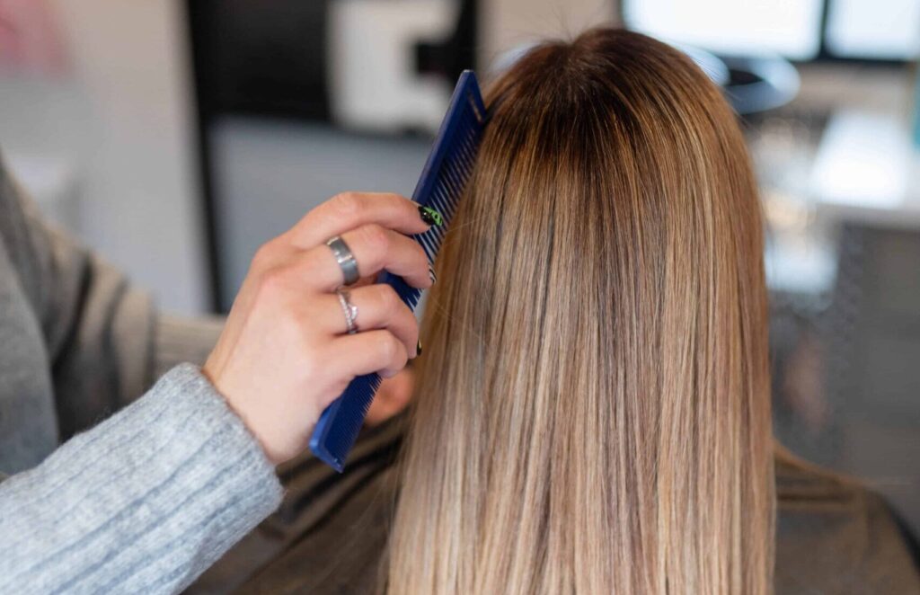 woman combing a woman's hair