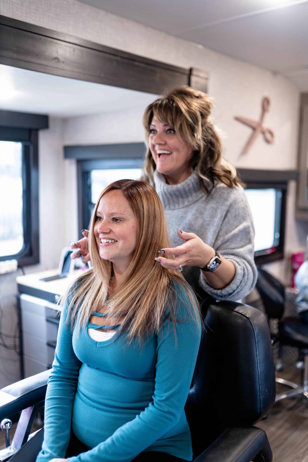 hairstylist behind woman in stylist chair