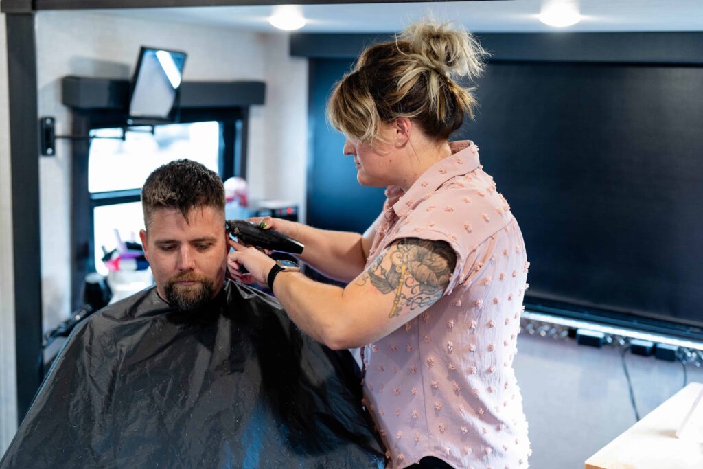 woman giving man a haircut